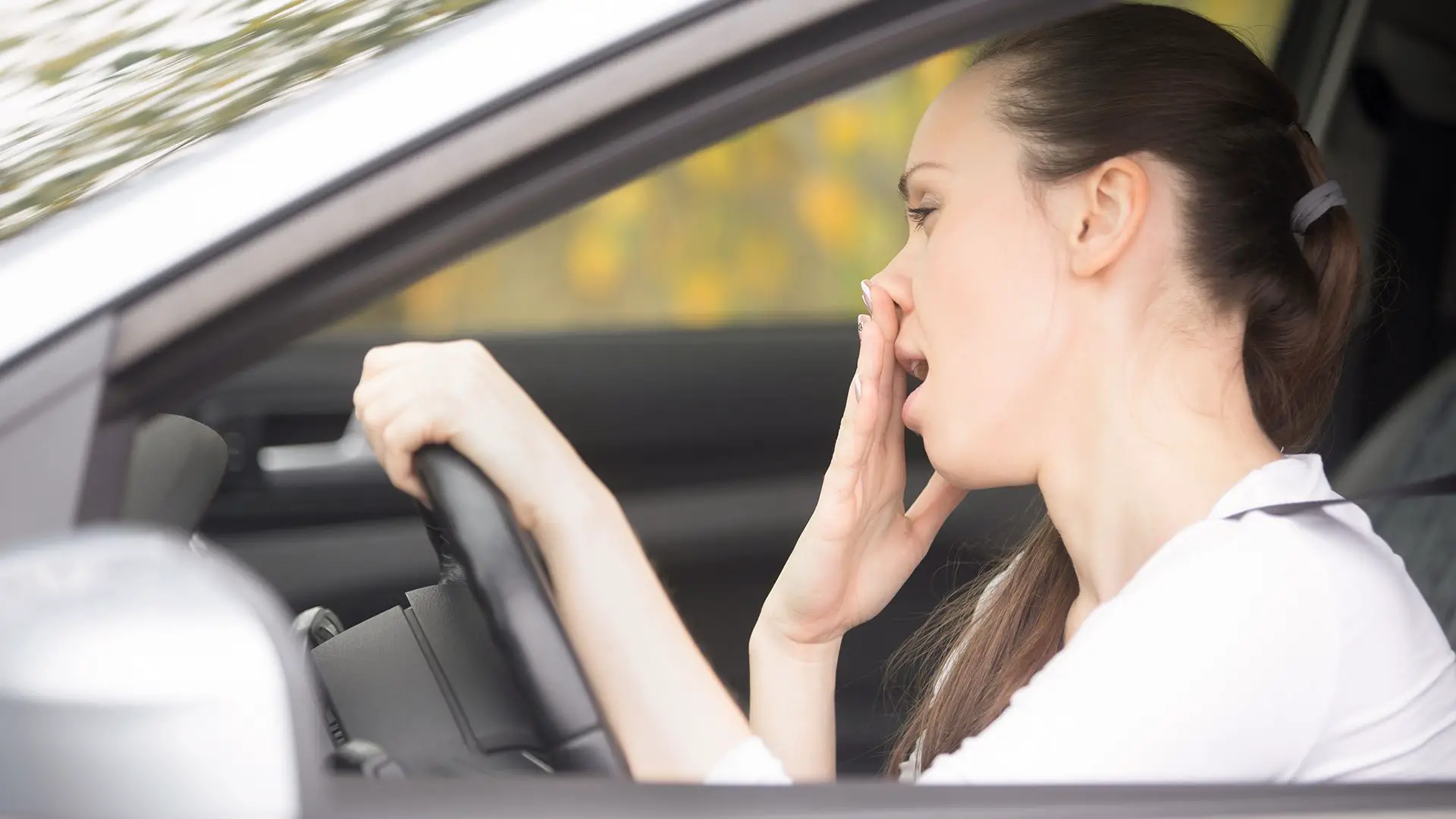 woman noticing bad smell in car
