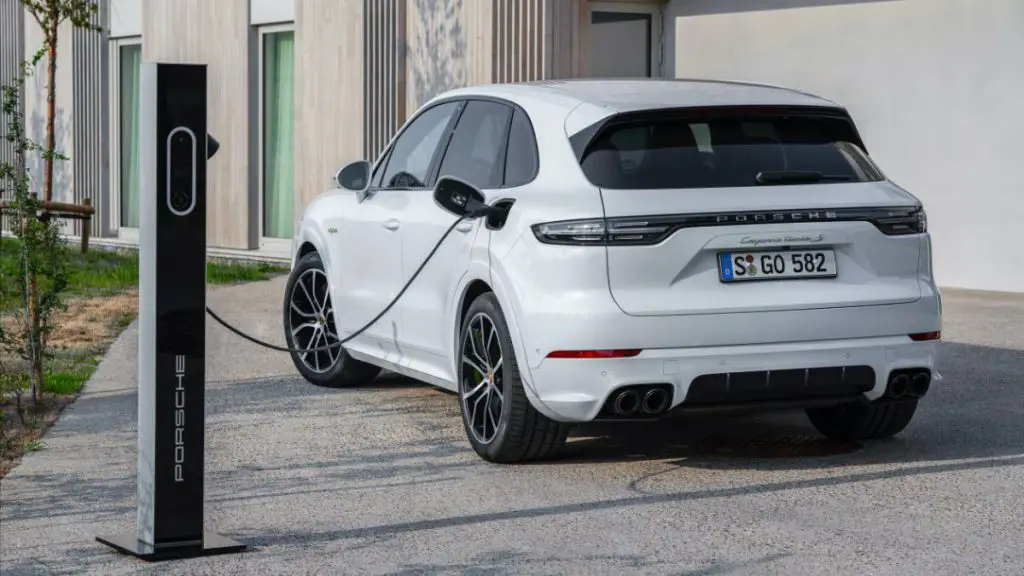 Plug-in hybrid Porsche Cayenne at charging station