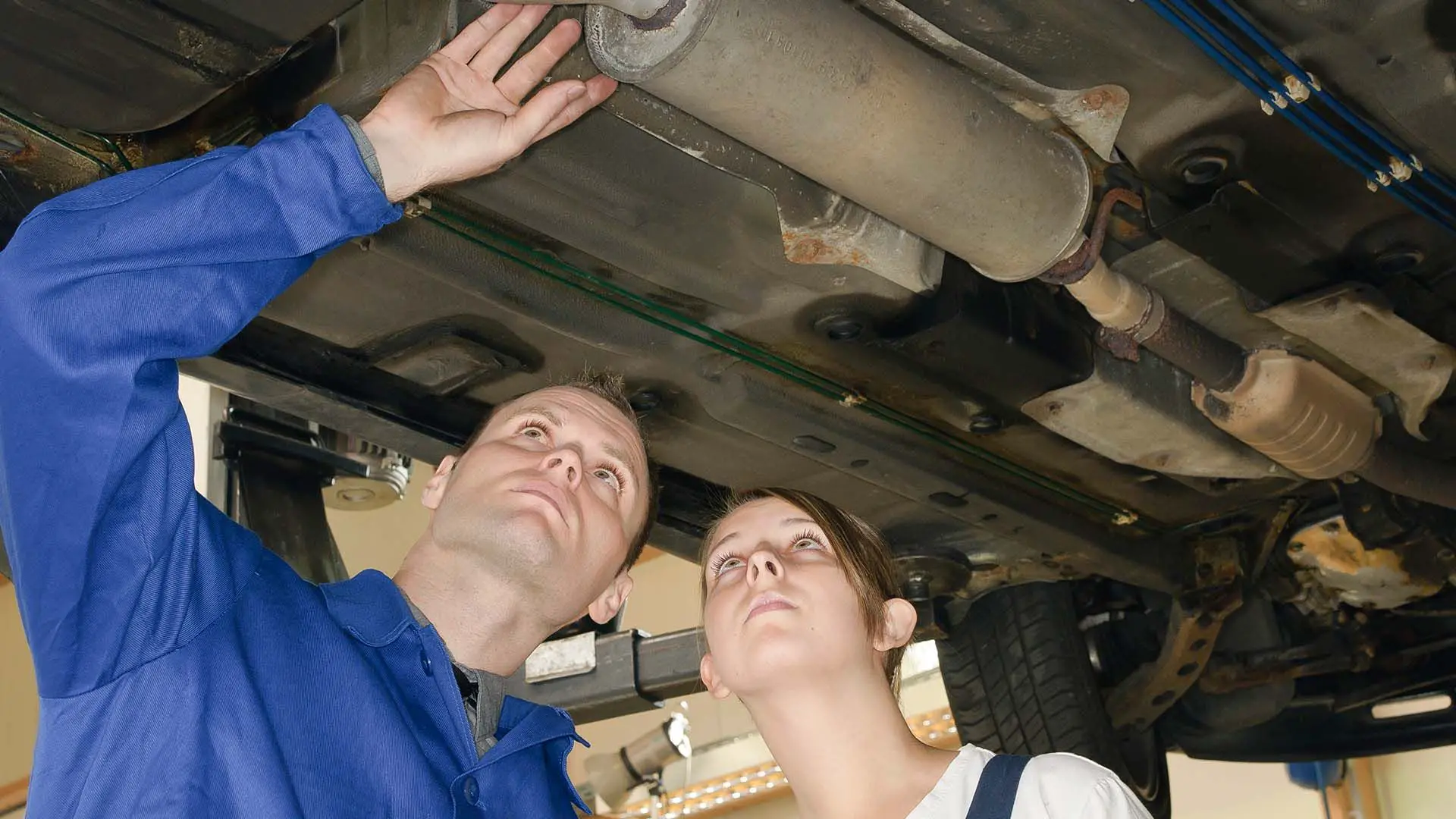 Mechanic checking a car's exhaust system
