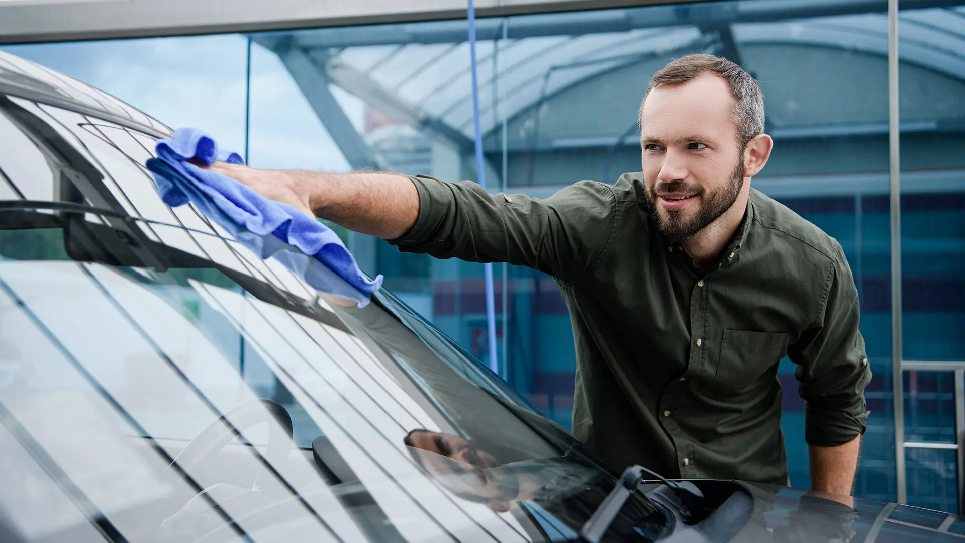 man cleaning windscreen